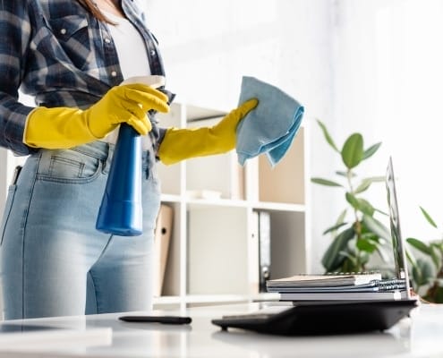 Best Office Cleaning Services Kamloops - Woman cleaning desk