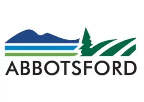 The logo for Abbotsford features blue mountains, a green tree, and green fields above the word "ABBOTSFORD" in bold, black letters on a white background, reflecting the city’s dedication to commercial cleaning and property maintenance.
