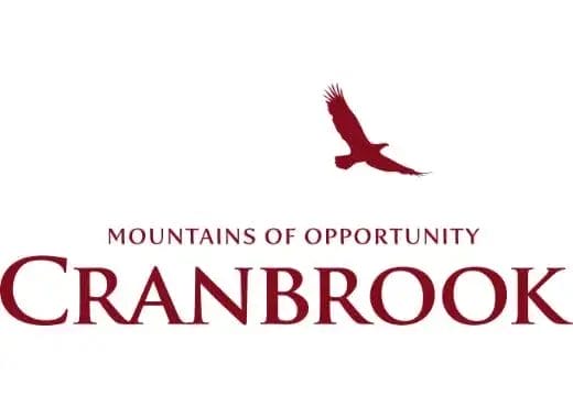Logo for Cranbrook with the slogan "Mountains of Opportunity" in red text, featuring a soaring bird silhouette above "Cranbrook" on a white background—a professional look perfect for businesses in janitorial cleaning or property maintenance.