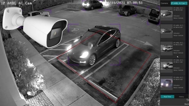Black-and-white surveillance footage shows a dark car parked in a lot at night, with several other cars visible. An illustrated camera overlay is in the corner, and a detection interface appears on the right side of the image.
